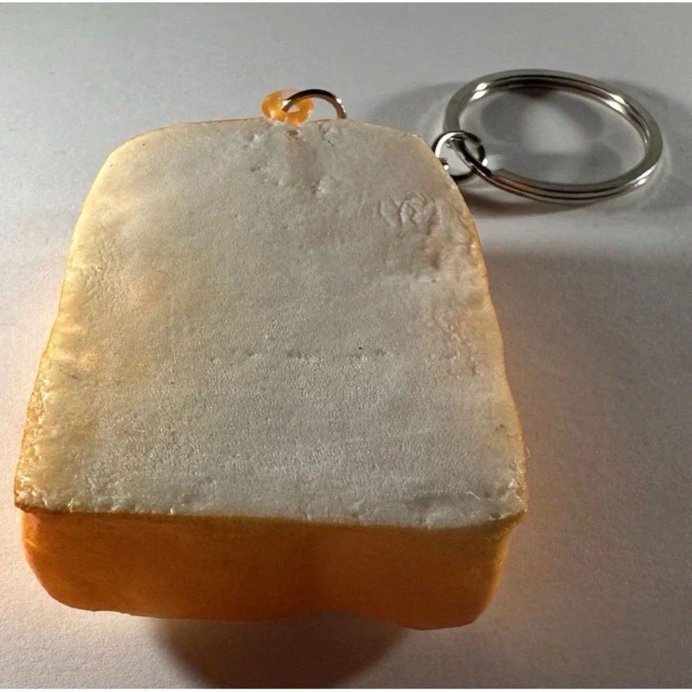 Cute Slice of toast keychain featuring playful smug facial expression
